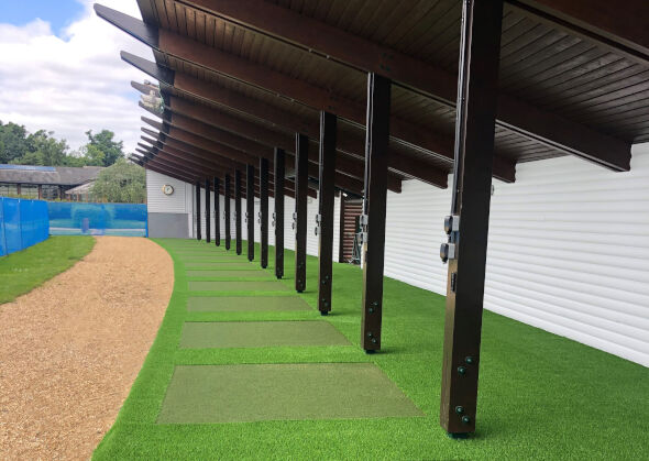 Oakley Covered outdoor tee line with light green synthetic grass boxes inside a dark green synthetic grass strip